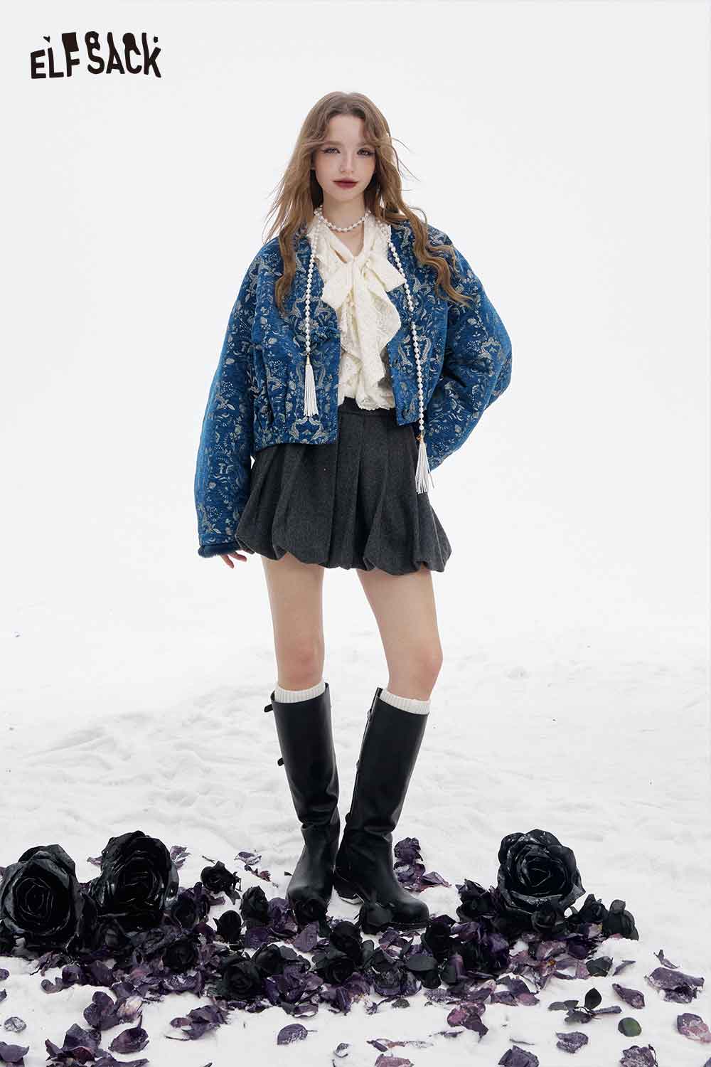 ELFSACK retro graphic short coat for women styled with a pleated skirt and knee-high boots in a snowy setting