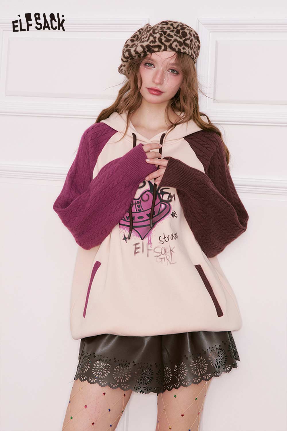 ELFSACK women's PU leather shorts paired with a cozy hooded sweater and beret for a stylish look
