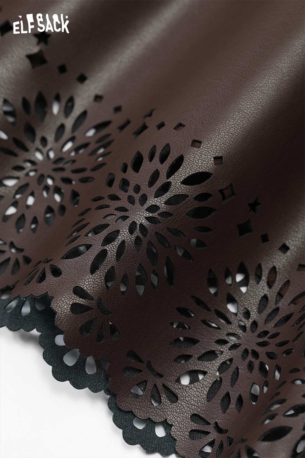 Detailed view of ELFSACK women's PU leather shorts with intricate cut-out designs for a stylish look