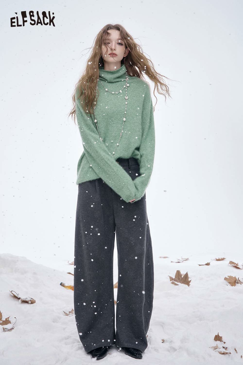 ELFSACK women's soft straight leg pants in dark grey paired with a cozy green sweater in a snowy setting