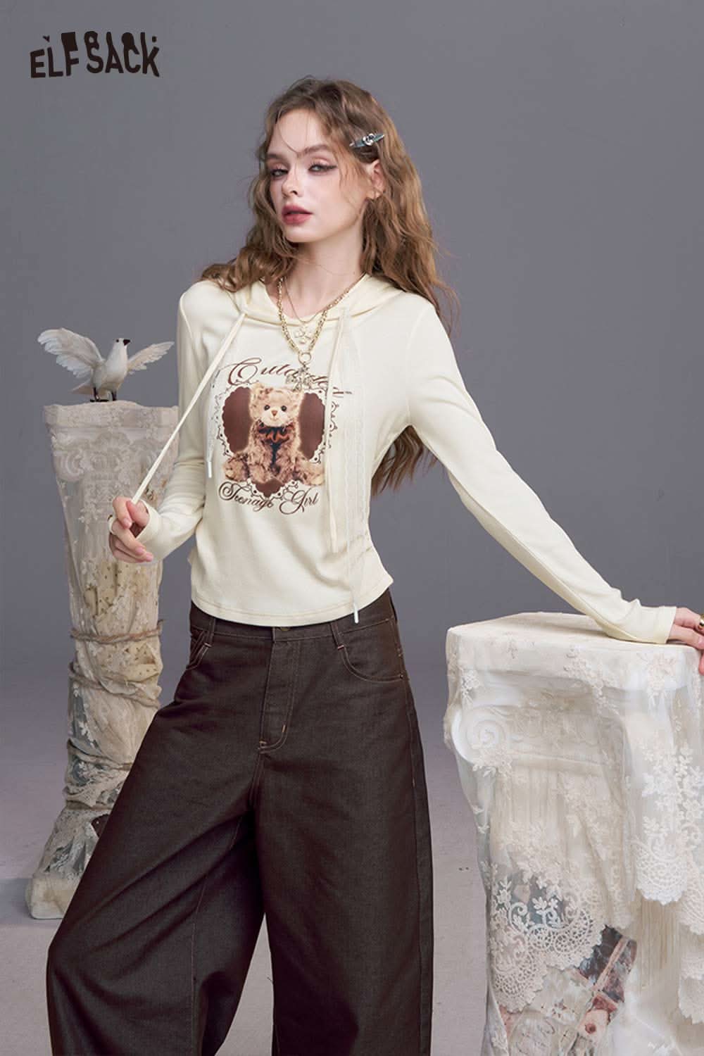 ELFSACK women's bear graphic hoodie in cream color featuring a playful bear design