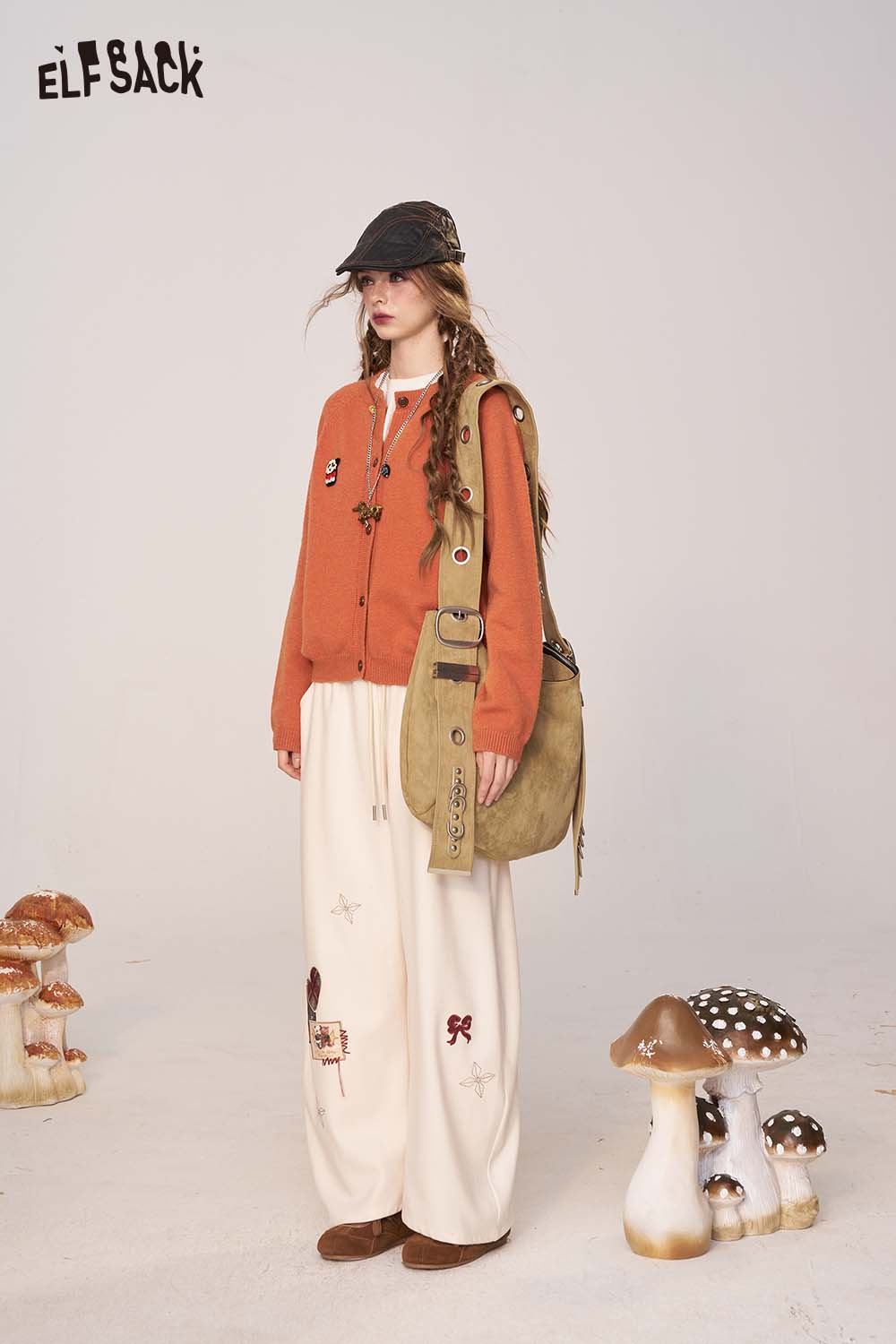ELFSACK women's cartoon embroidery knit cardigan in orange worn with stylish bag and pants