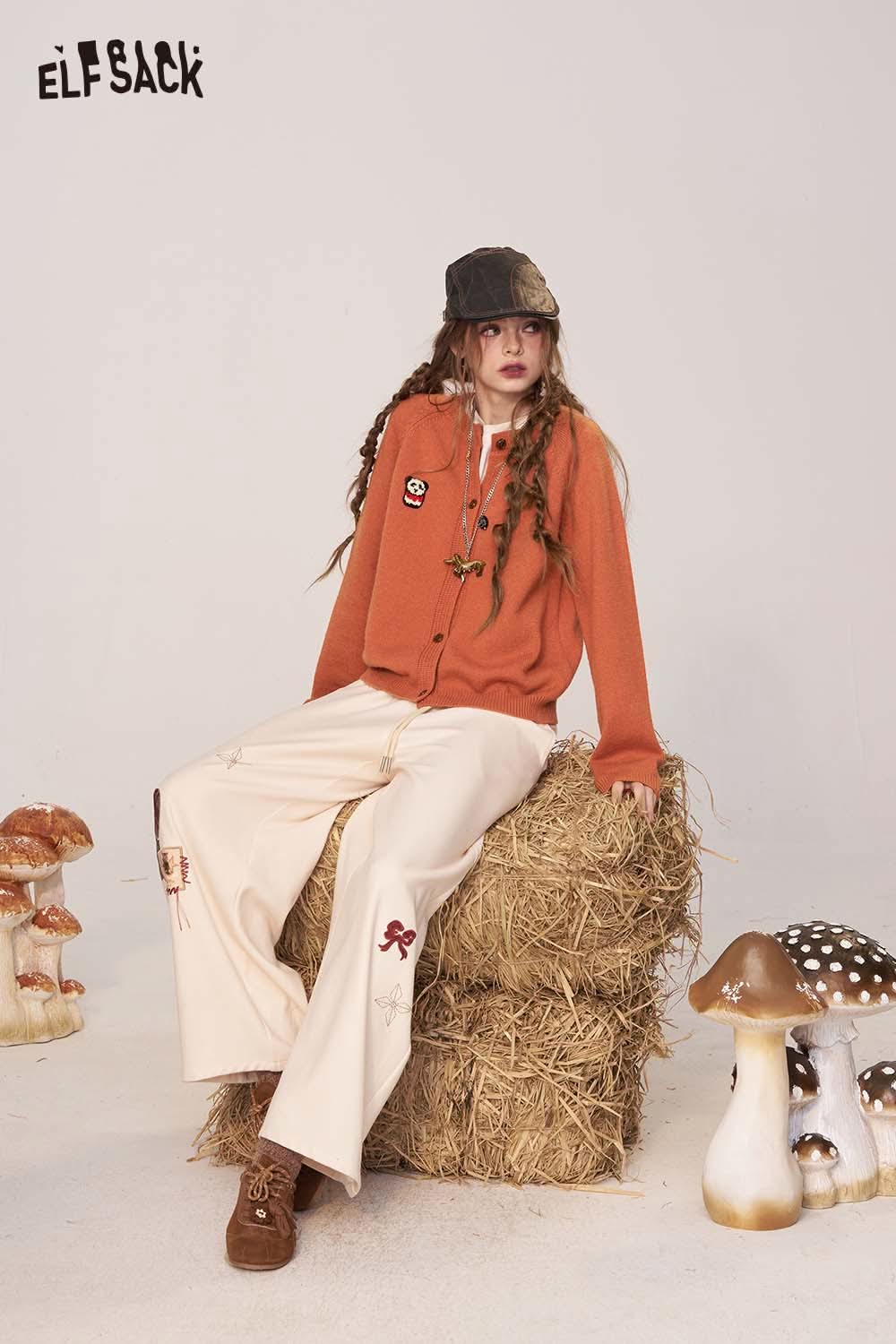 ELFSACK women's cartoon embroidery knit cardigan in orange, worn with cream pants and styled casually