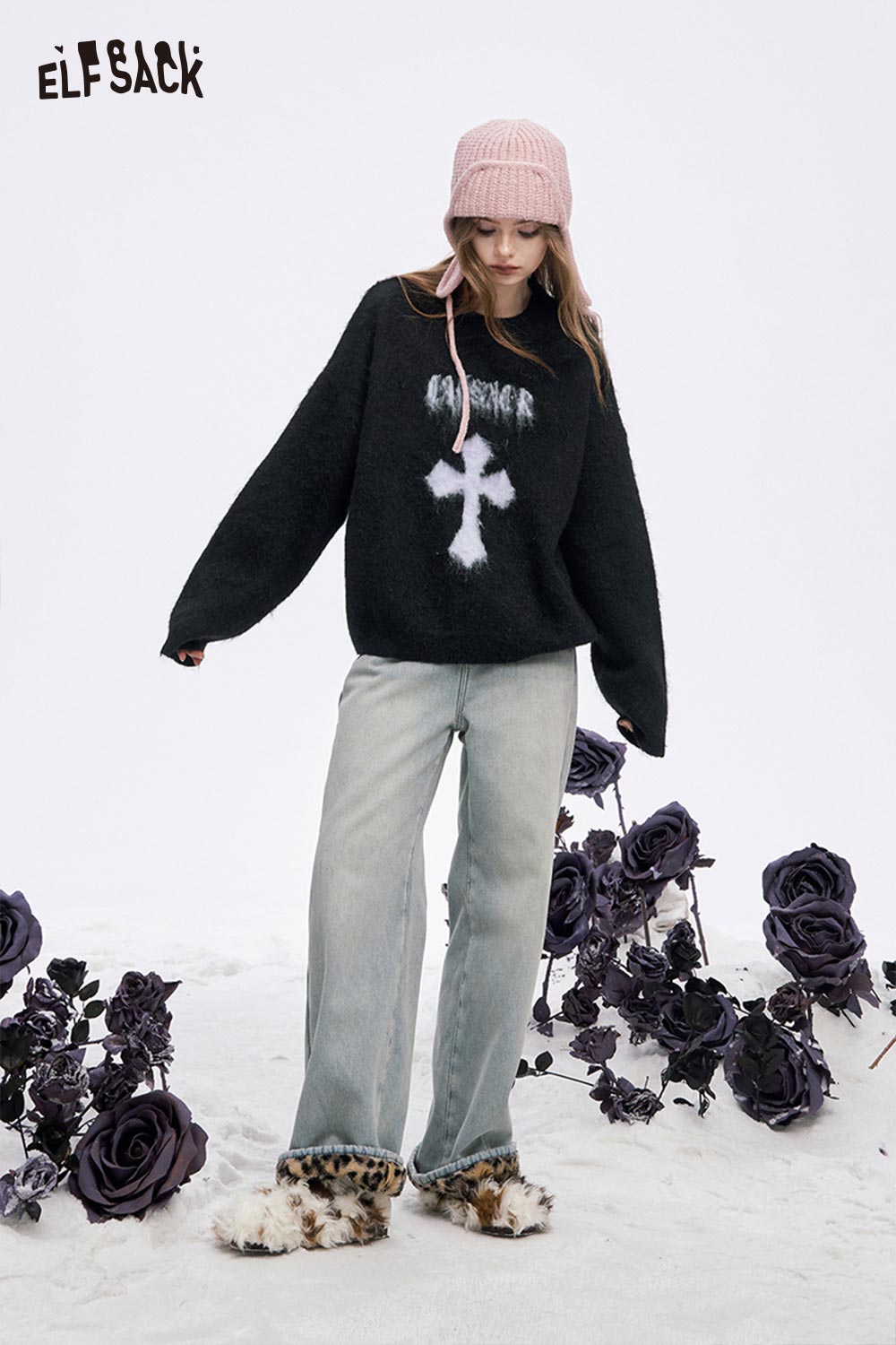 Women's casual cross graphic sweater in black with a soft texture, styled with light jeans and accessories