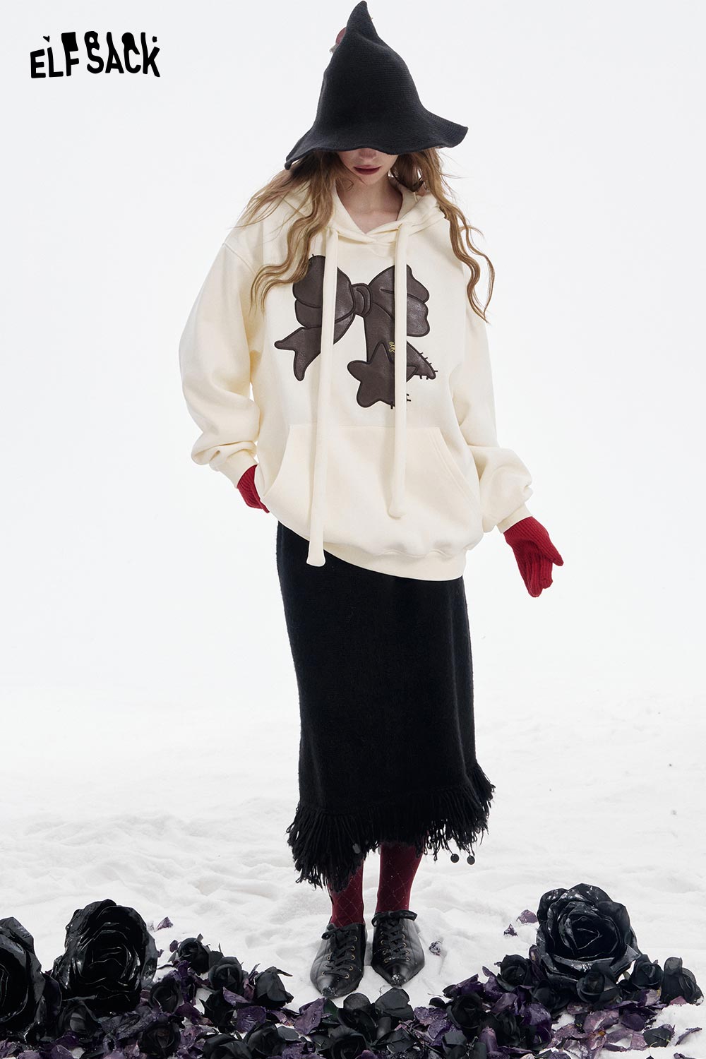 ELFSACK women's casual graphic hoodie in cream with bow design, paired with a black skirt and red gloves