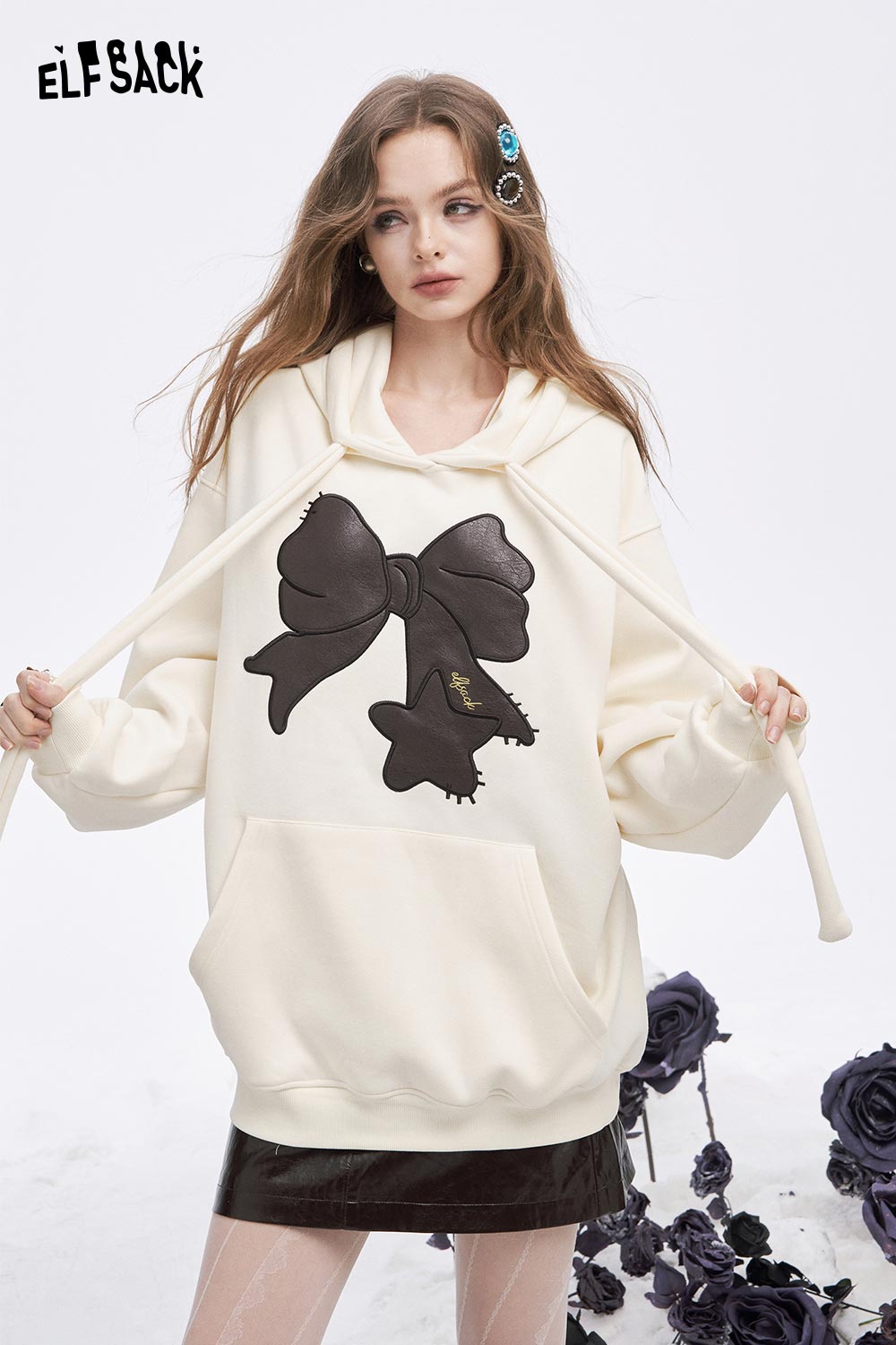 ELFSACK women's casual graphic hoodie in cream with a large bow design and a front pocket