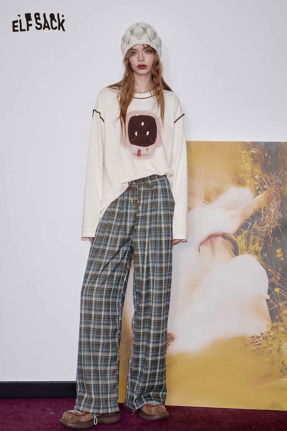 ELFSACK women's check pattern relaxed fit trousers styled with a graphic long sleeve tee and cozy accessories