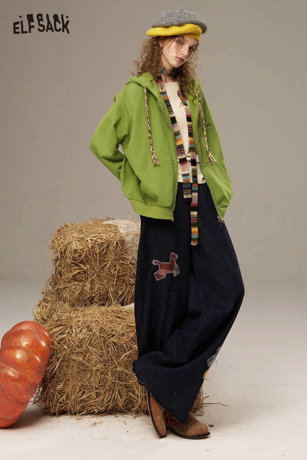 Model wearing a women's colorful hooded jacket paired with a cozy outfit for a stylish look.