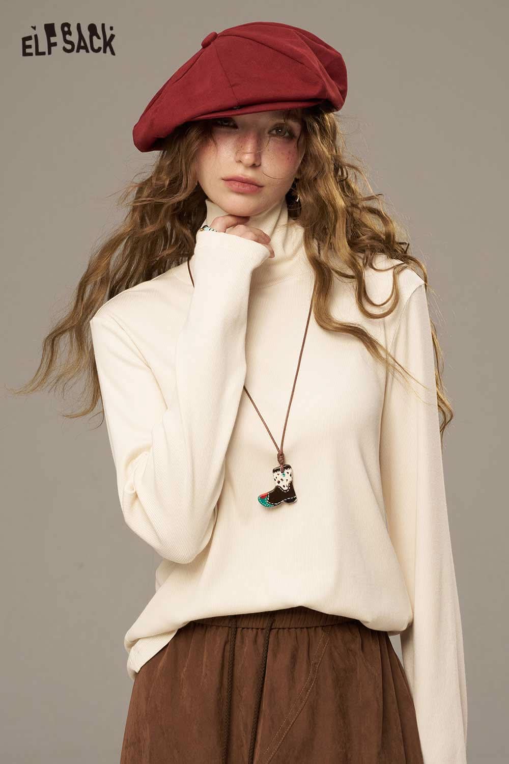 ELFSACK women's cozy turtleneck sweater in cream, styled with a red beret and boho accessories