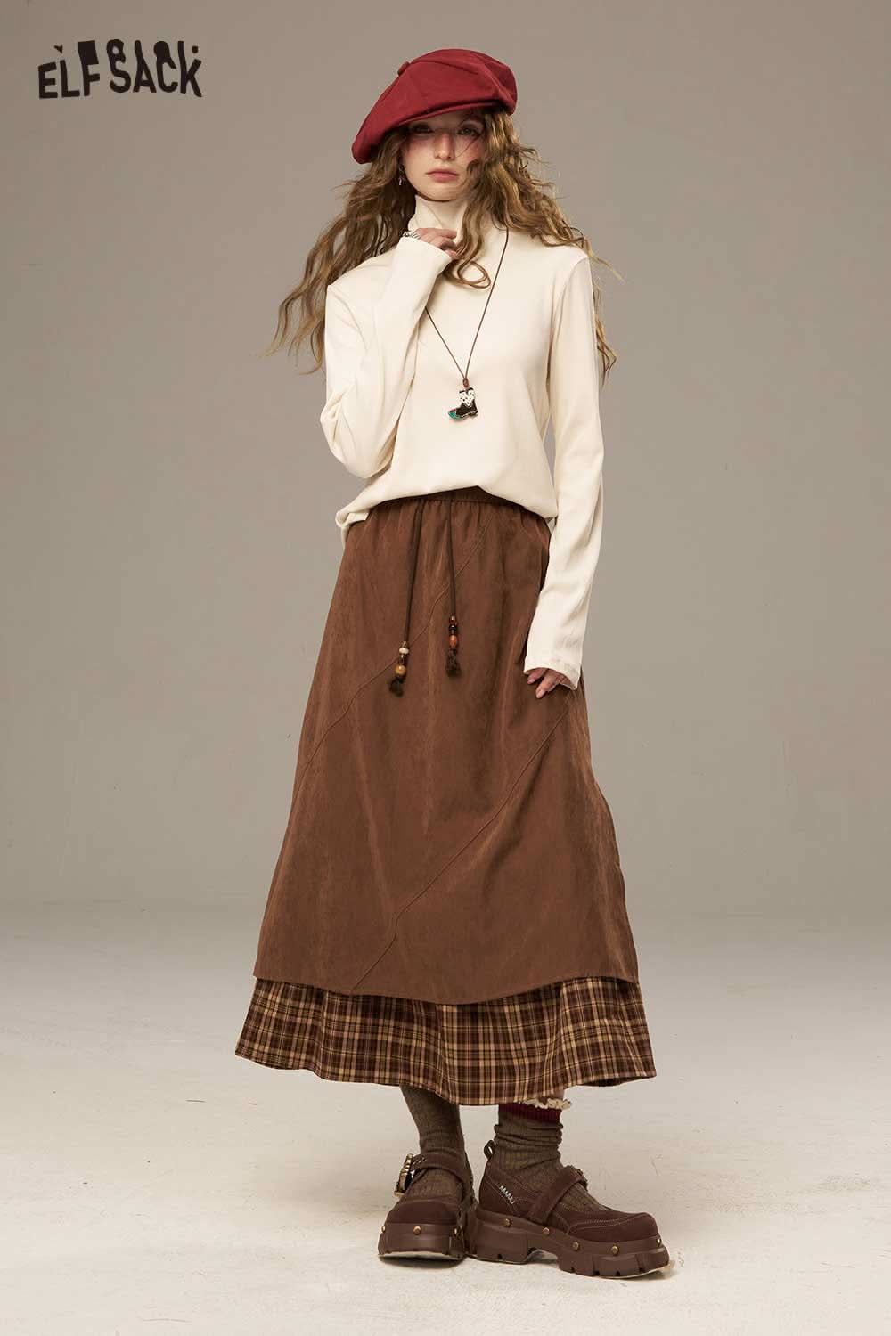 Model wearing ELFSACK women's cozy turtleneck sweater paired with a brown skirt for a stylish autumn look