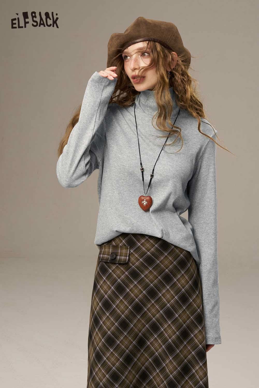 ELFSACK women's cozy turtleneck sweater in grey paired with a plaid skirt and accessories