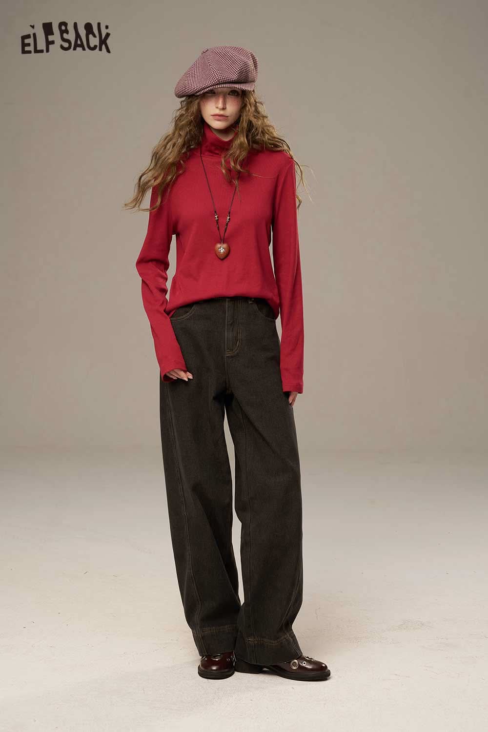 Model wearing a red ELFSACK women's cozy turtleneck sweater paired with dark wide-leg pants