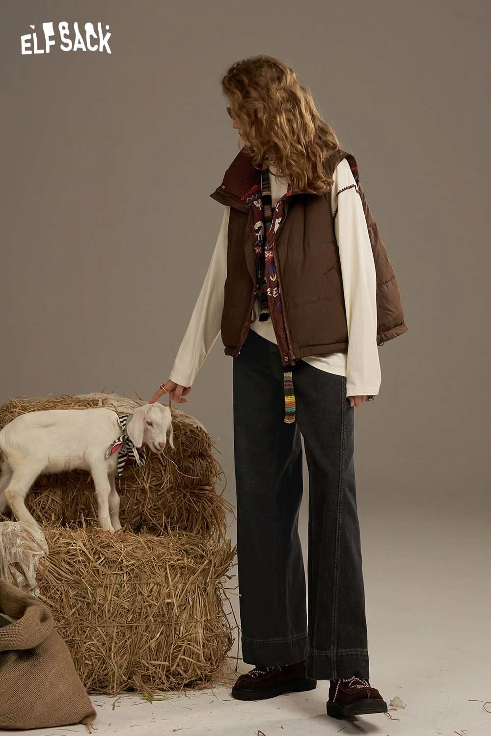 ELFSACK women's denim straight leg pants styled with a brown vest and a goat on a haystack