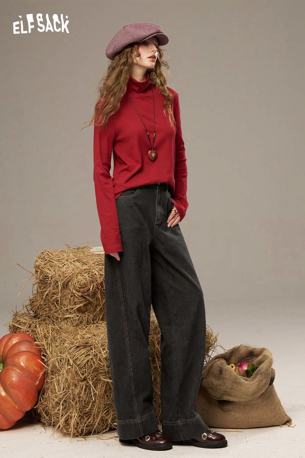 ELFSACK women's denim straight leg pants paired with a red turtleneck and stylish cap in a rustic setting