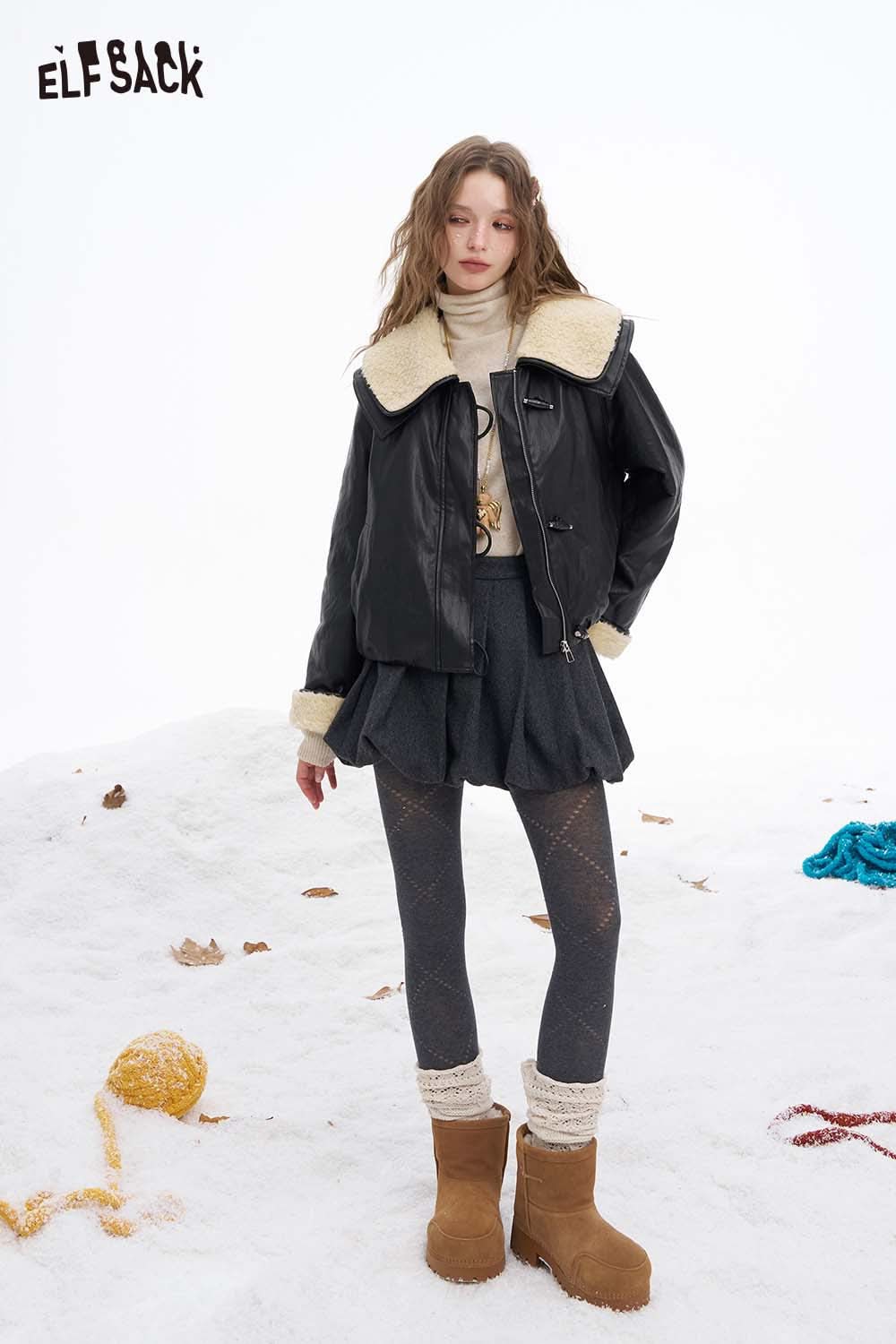 Trendy women's faux leather jacket with plush collar styled with a skirt and winter boots in a snowy setting