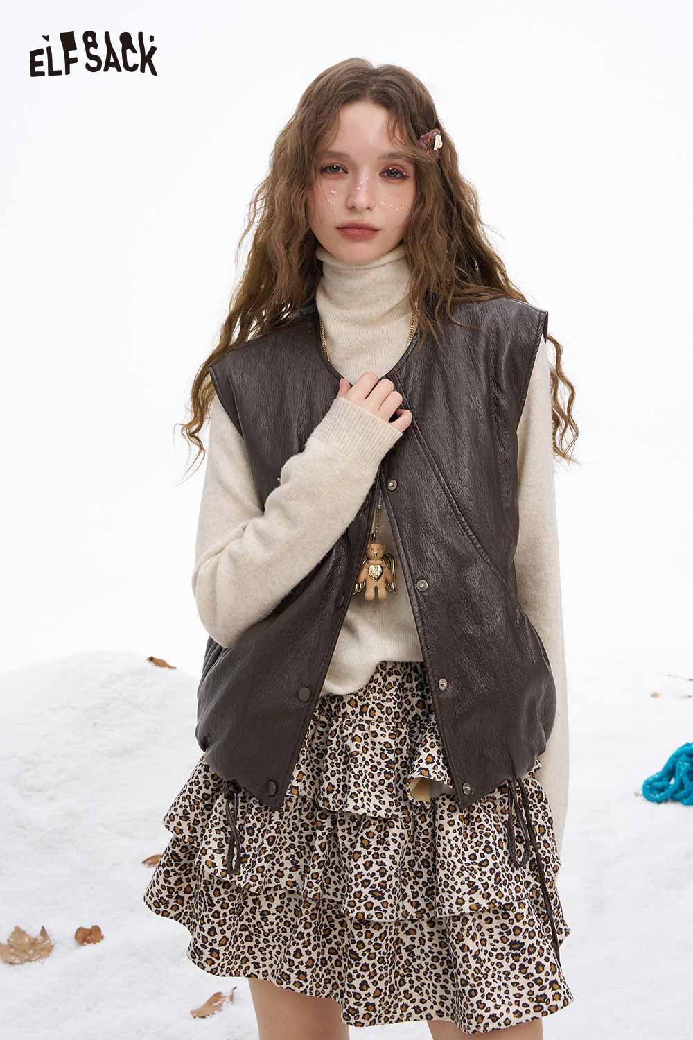 ELFSACK women's faux leather sleeveless jacket styled with a cozy turtleneck and patterned skirt