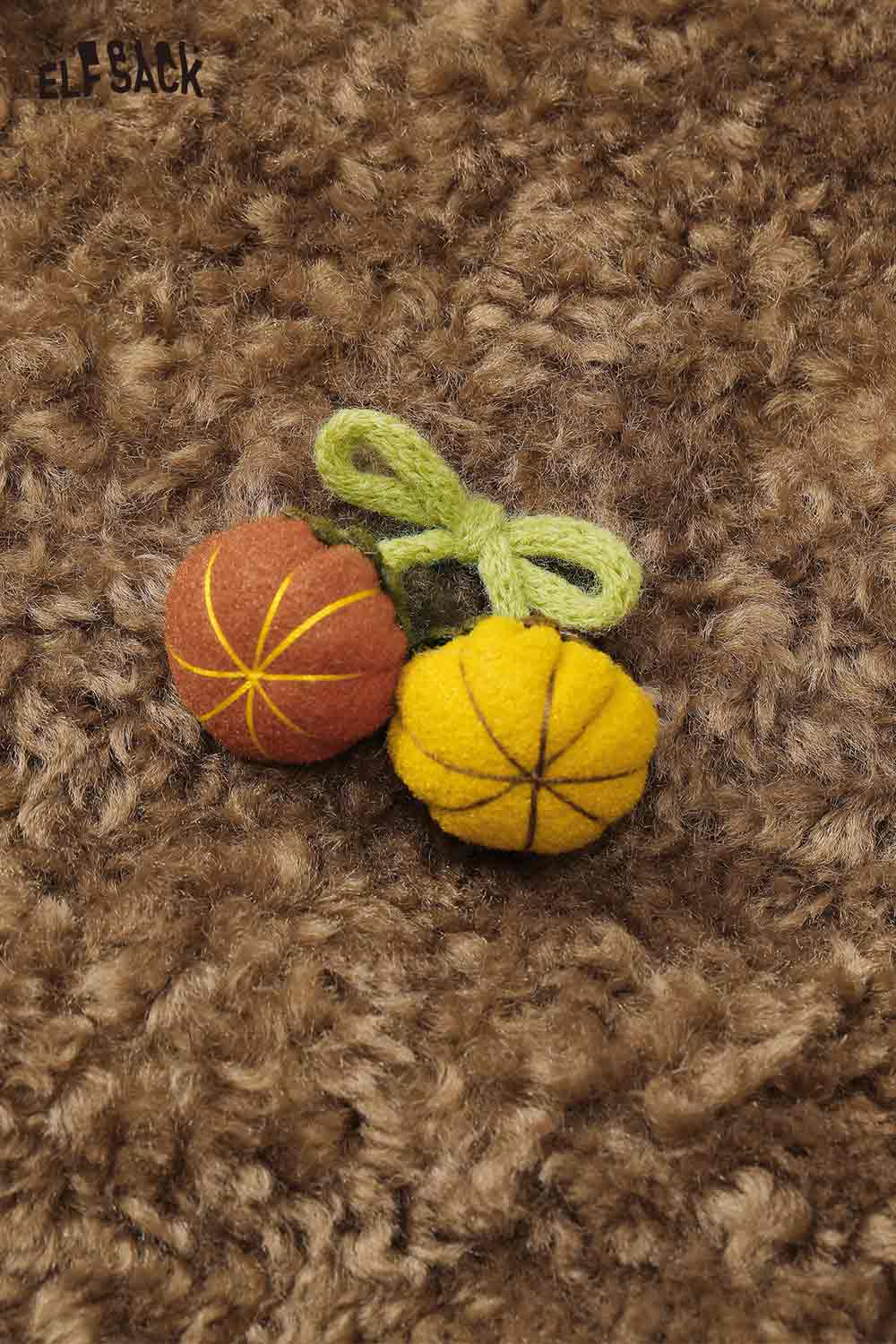 Detail of ELFSACK women's faux shearling pumpkin jacket featuring cute pumpkin appliques