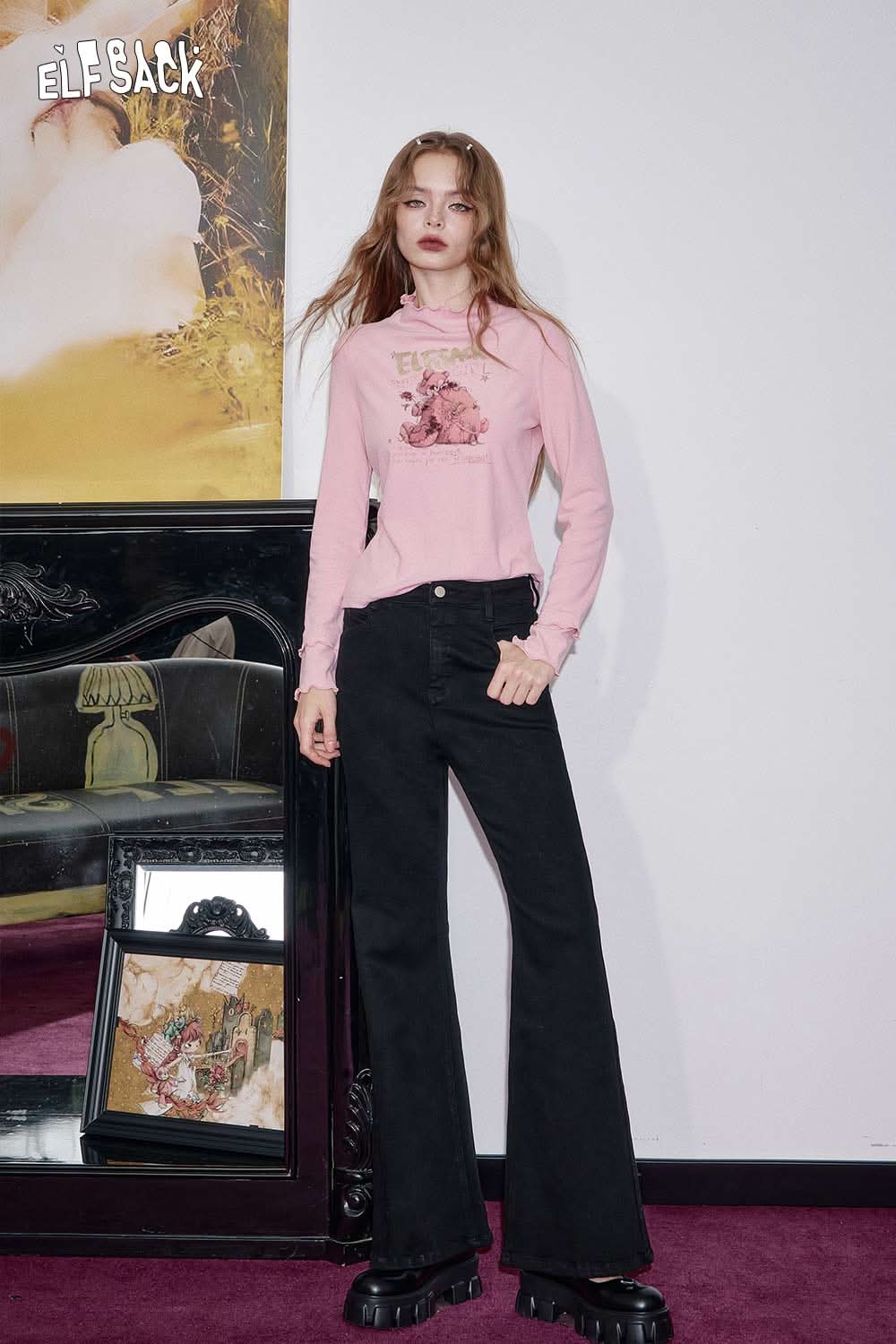 Model wearing ELFSACK women's flared stretch denim jeans paired with a pink long-sleeve top against a stylish backdrop