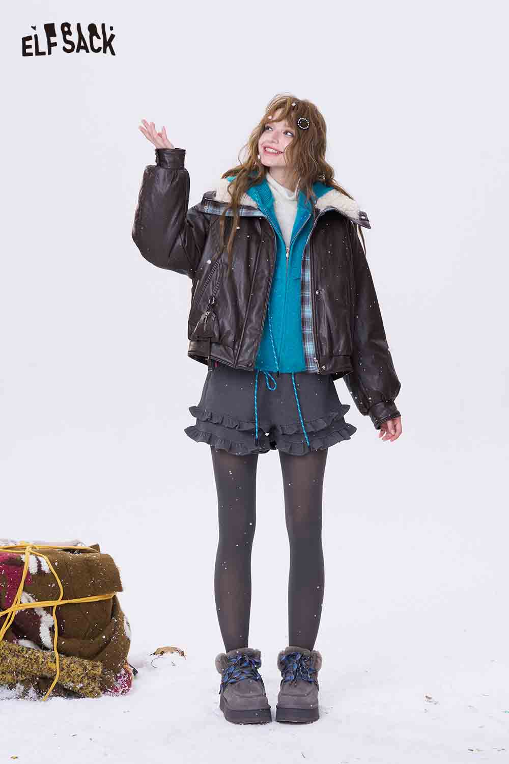 Women's fleece hooded sweater in turquoise styled with a brown bomber jacket and a playful skirt