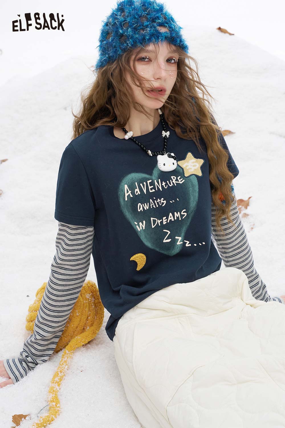 ELFSACK women's graphic embroidered long sleeve tshirt with unique adventure design in a cozy setting