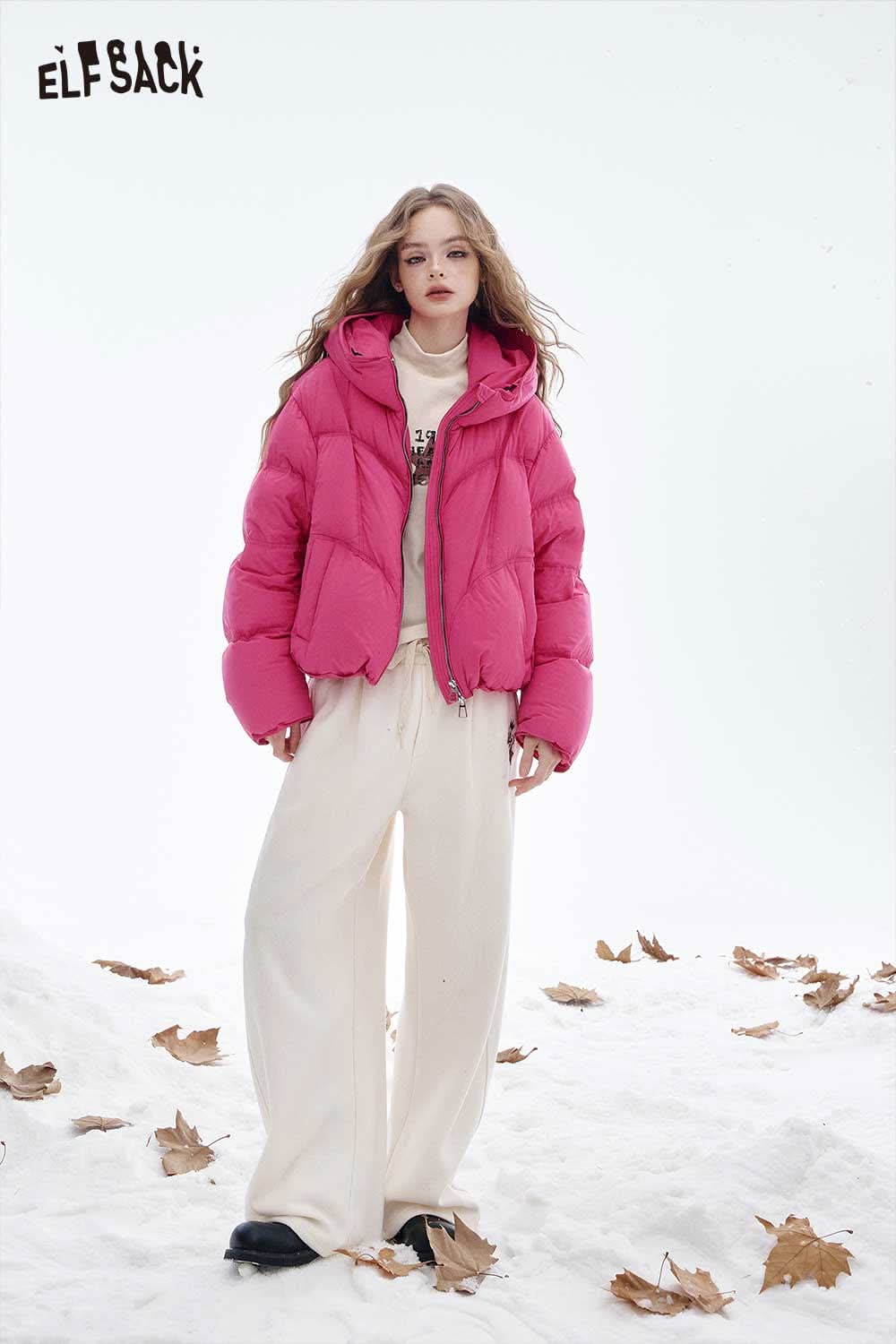 ELFSACK women's graphic long sleeve t-shirt styled under a pink puffer jacket outdoors