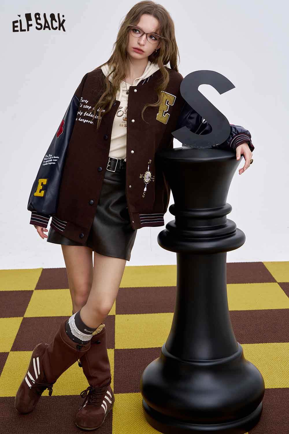 ELFSACK women's graphic long sleeve tshirt paired with a varsity jacket and a stylish skirt