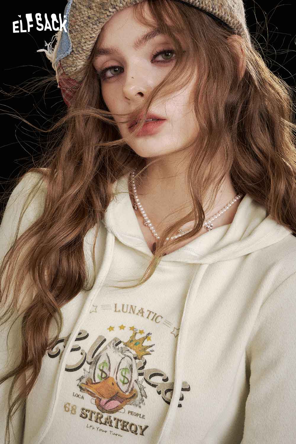 ELFSACK women's graphic long sleeve tshirt in cream with a unique print and cozy fit