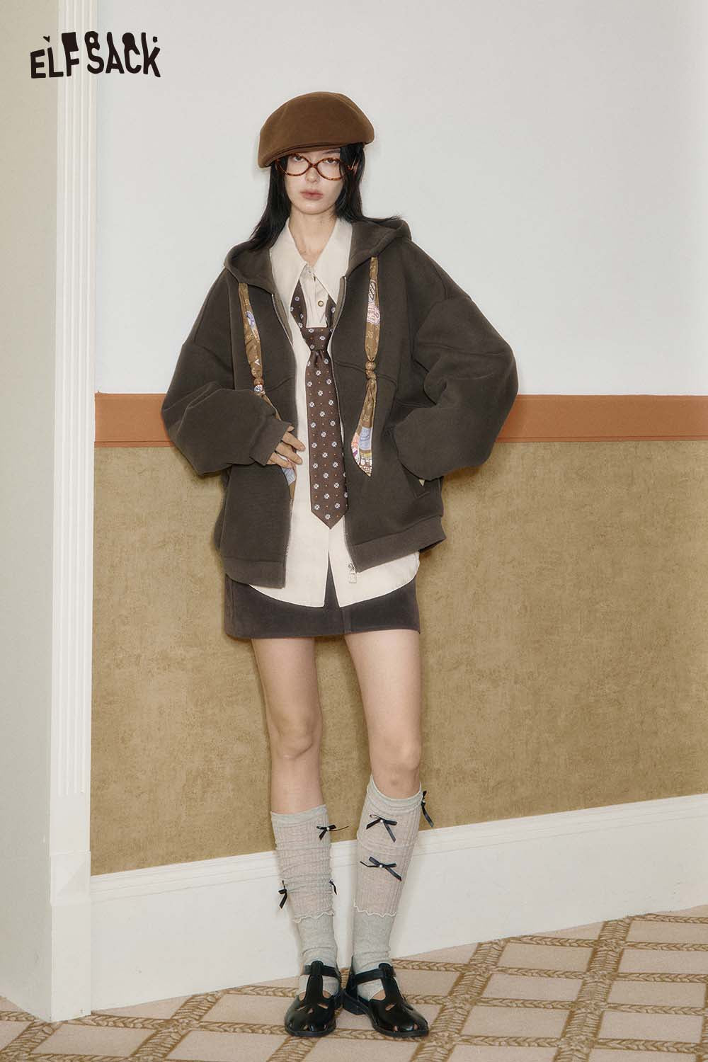 ELFSACK women's graphic print hoodie in brown with unique design, styled with a shirt and accessories