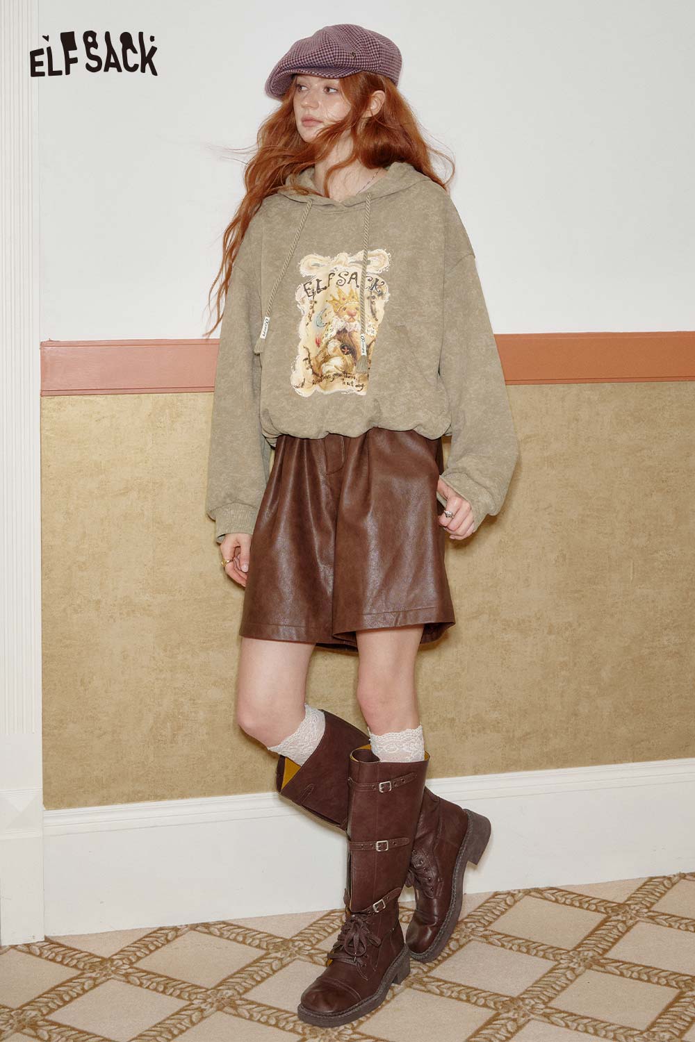 ELFSACK women's graphic print hoodie in olive green with a stylish design, paired with a brown leather skirt