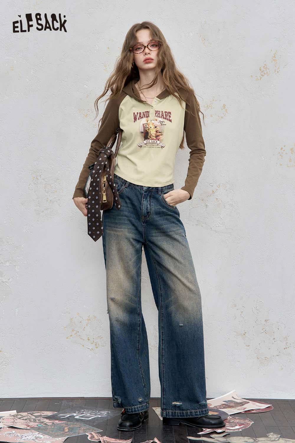 ELFSACK women's graphic print hoodie featuring a unique design in a stylish outfit with denim jeans