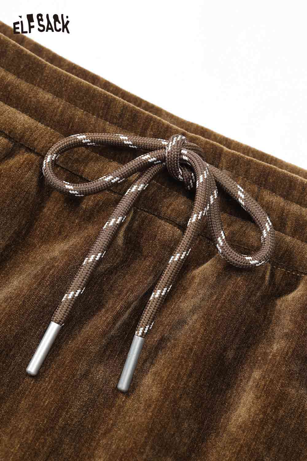 Close-up of ELFSACK women's graphic sweatshirt and skirt set featuring stylish drawstring detail