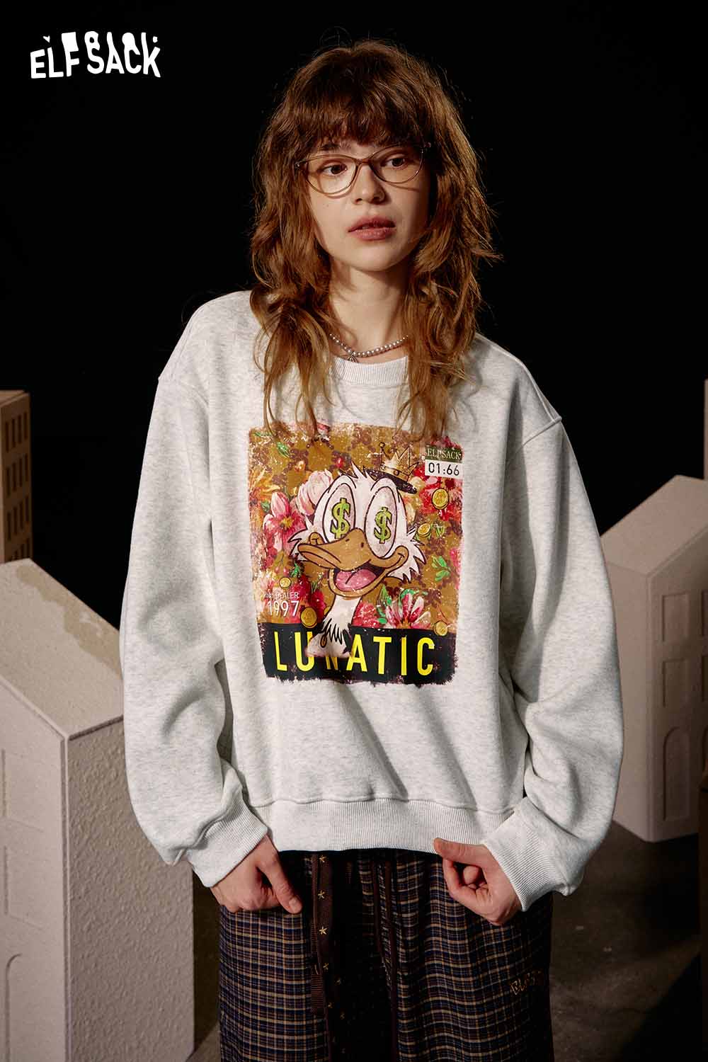 ELFSACK women's graphic sweatshirt featuring a colorful cartoon design and relaxed fit for casual wear