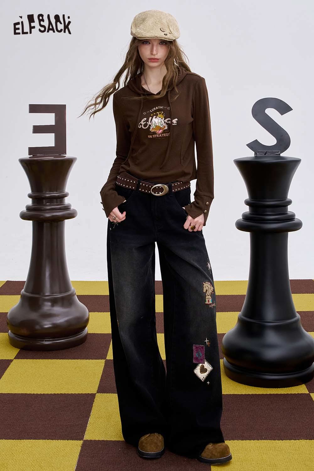 ELFSACK women's graphic wide leg pants in black featuring unique patches and a relaxed fit