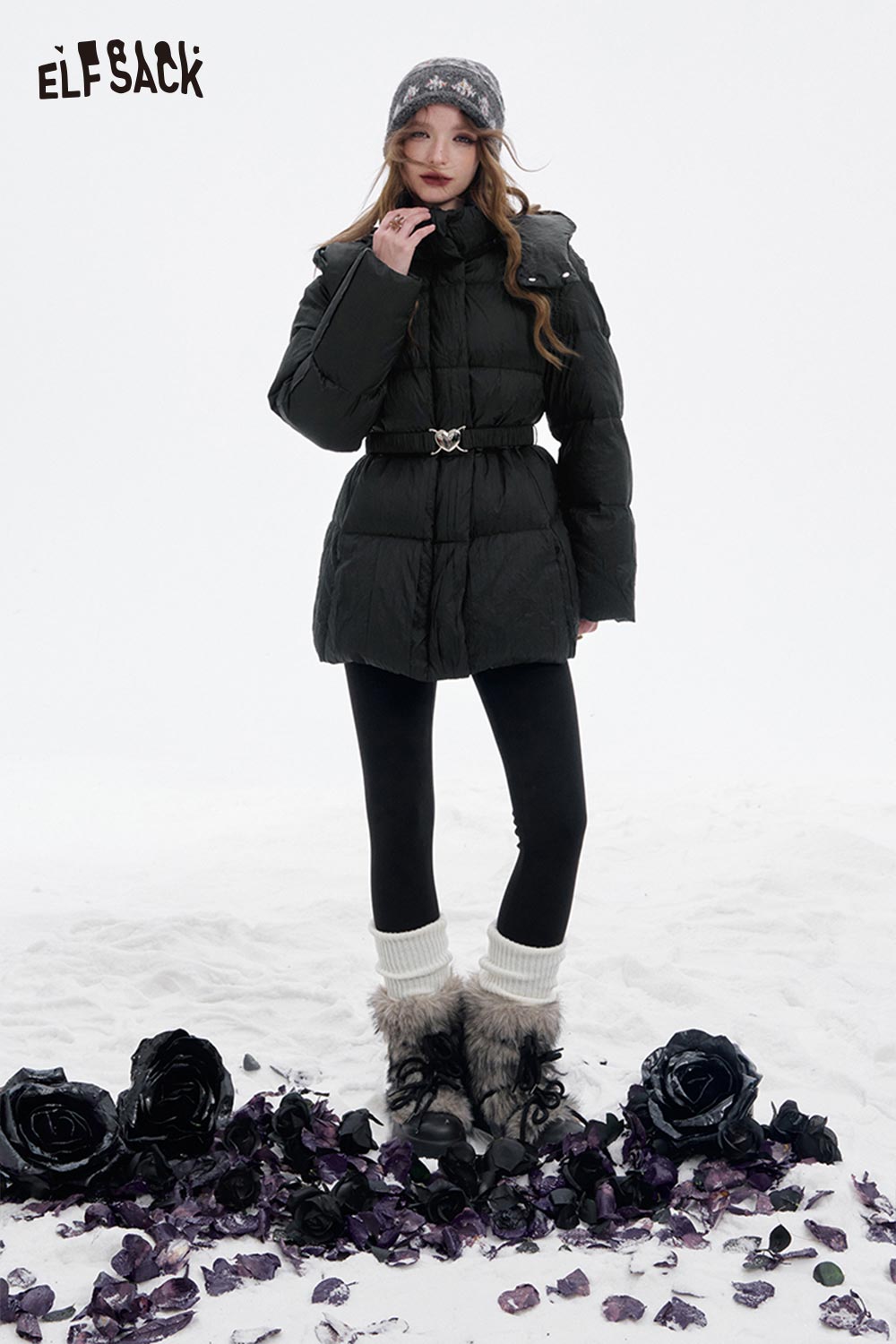 Stylish women's heart belt puffer coat by ELFSACK, perfect for winter layering in snow.