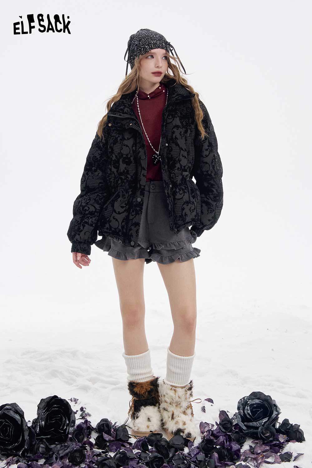 Trendy model wearing a stylish outfit showcasing a women's high neck pearl t-shirt under a black floral jacket