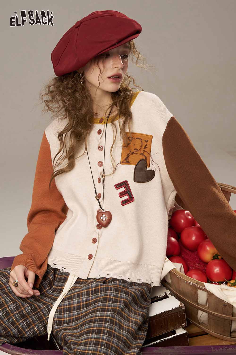 ELFSACK women's knitted jacket with colorful sleeves and playful patch details for a cozy look