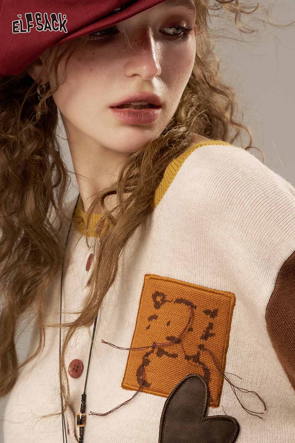 ELFSACK women's knitted jacket featuring colorful patches and a cozy design for stylish layering