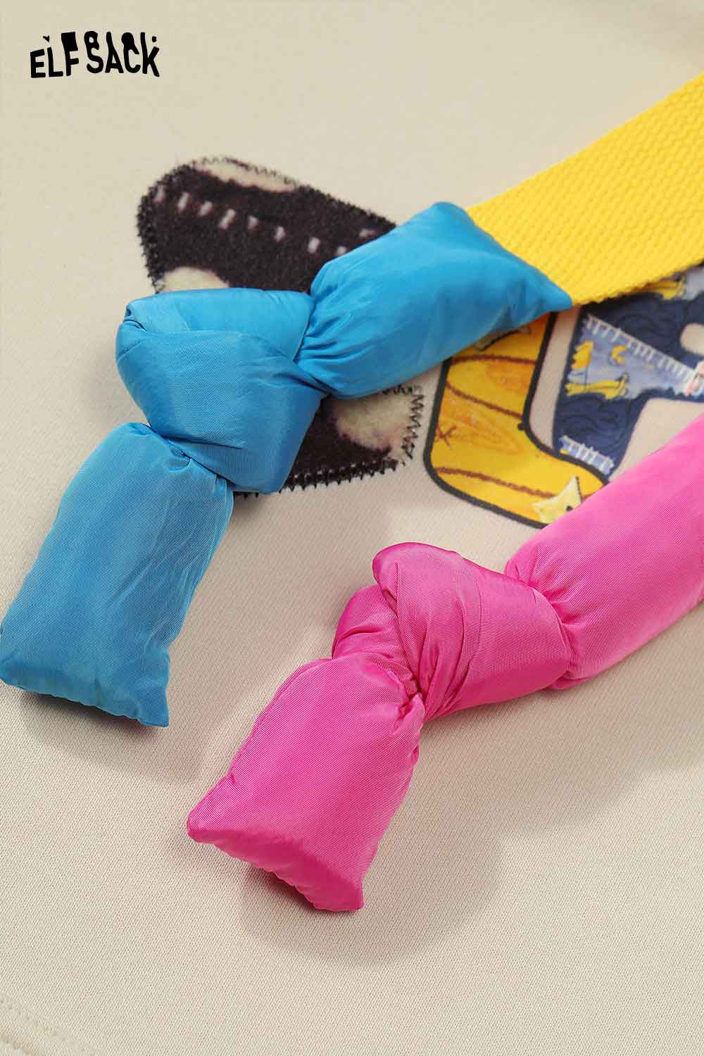 Colorful design detail of ELFSACK women's letter graphic hoodie with blue and pink knots