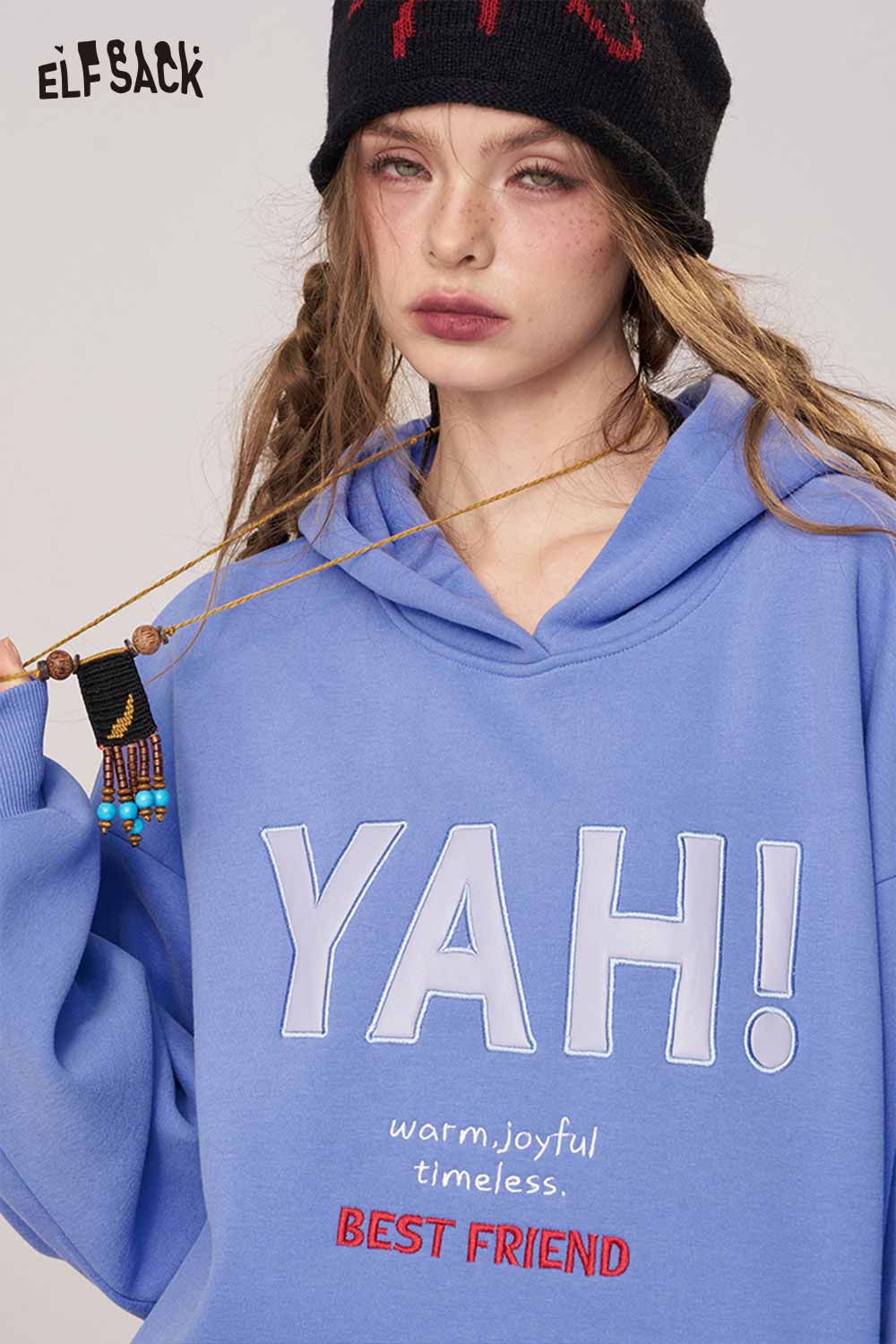 Women's loose fit hooded sweatshirt in blue with cheerful graphic design and cozy style