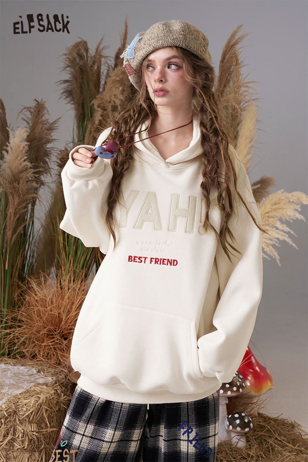 ELFSACK women's loose fit hooded sweatshirt in cream with fun graphics and cozy design
