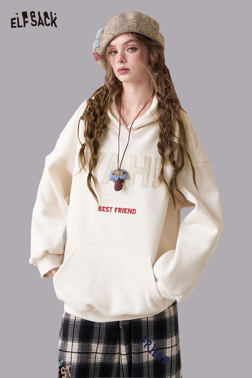 ELFSACK women's loose fit hooded sweatshirt in cream with embroidered text and roomy design for comfort.