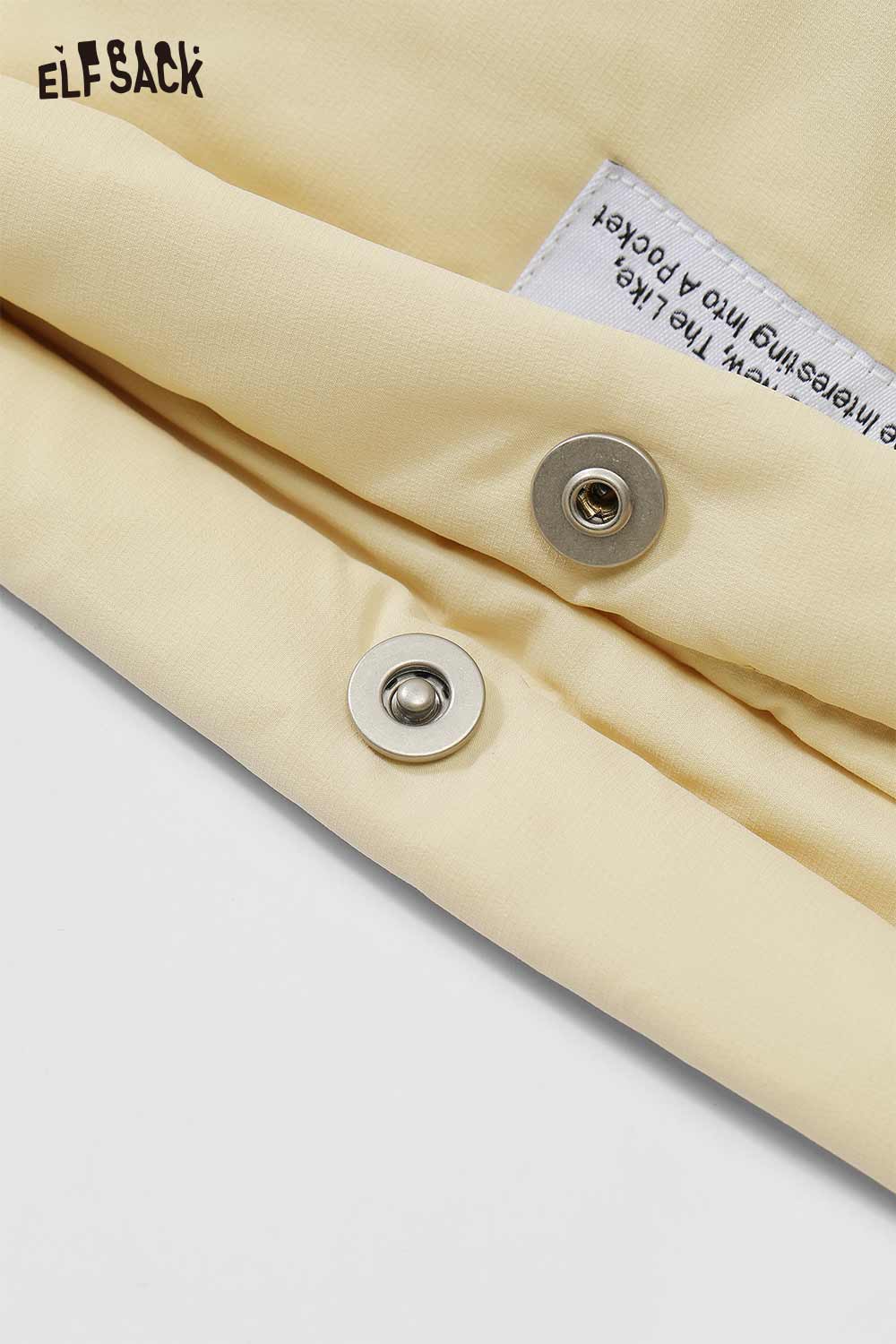 Close-up of ELFSACK women's nylon puffer jacket showing button and fabric details in soft yellow color