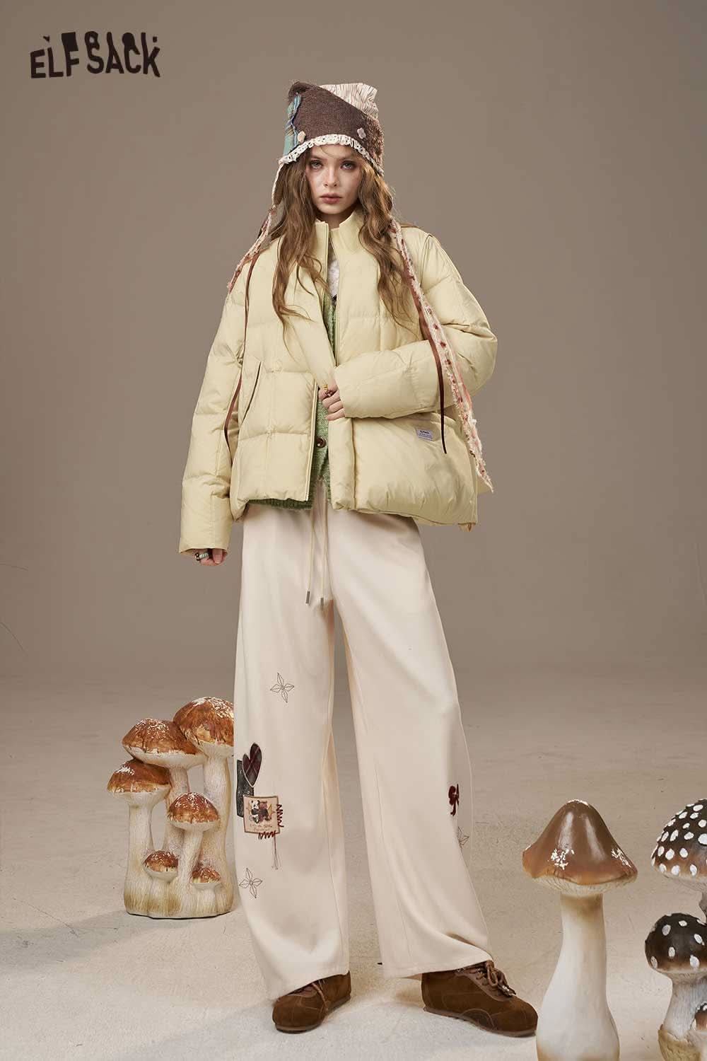 ELFSACK women's nylon puffer jacket in light yellow, styled with embroidered pants and a fashionable hat