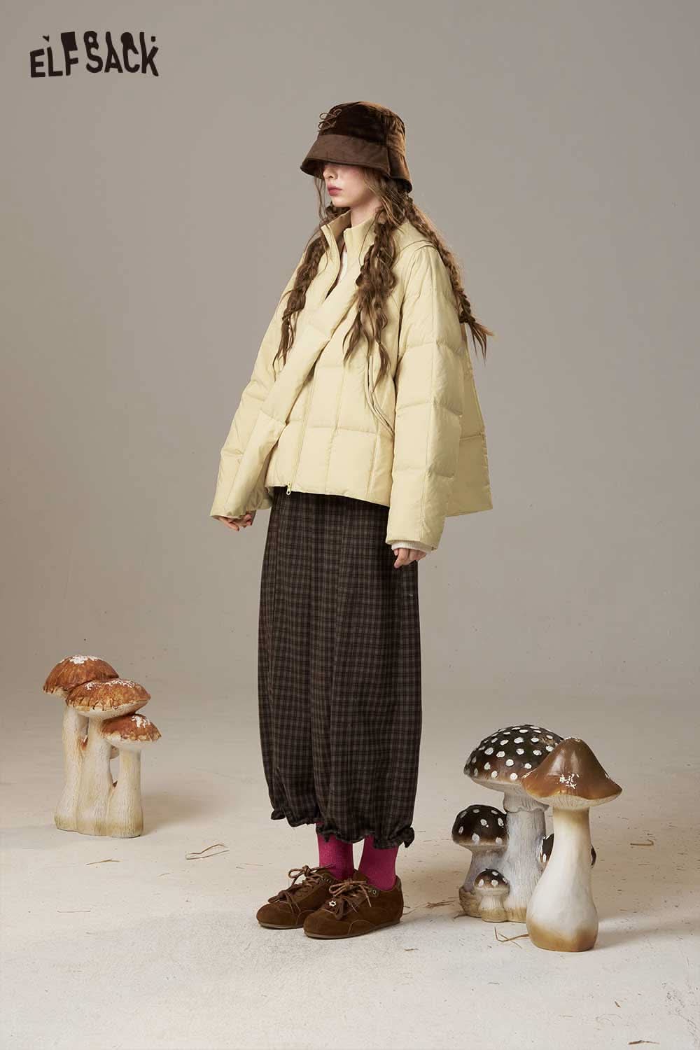 ELFSACK women's nylon puffer jacket in yellow paired with casual brown pants and a stylish hat