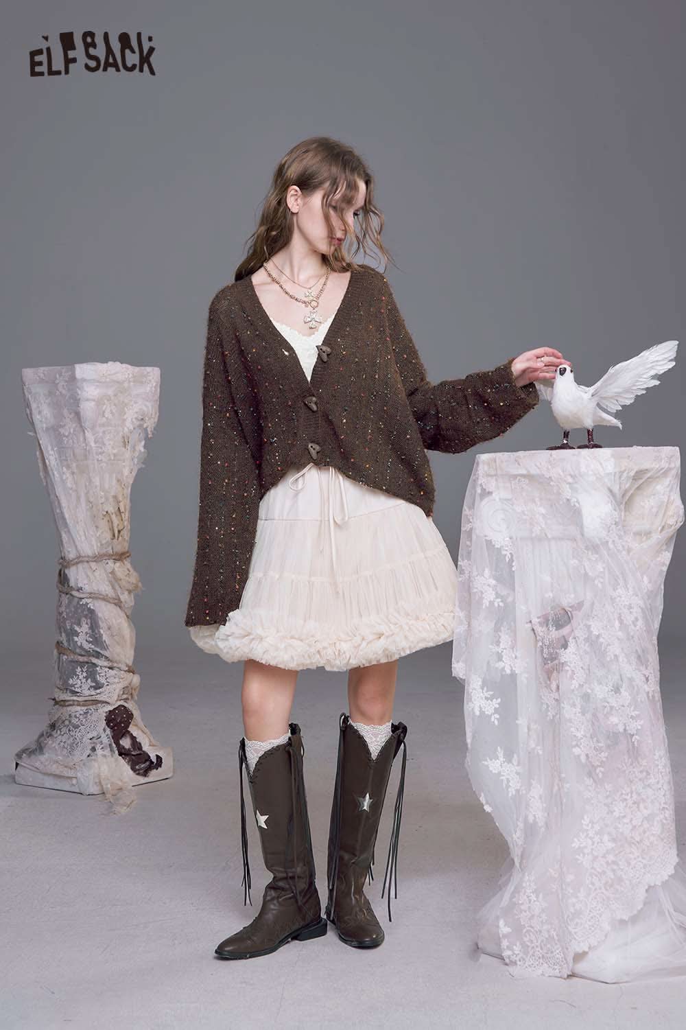 ELFSACK women's open front cardigan in brown worn over a white dress with knee-high boots