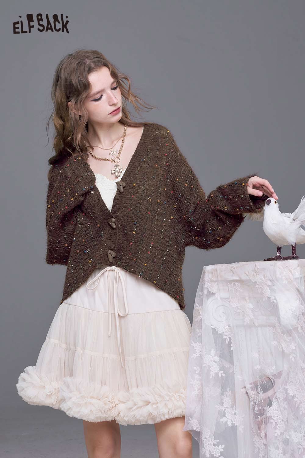 ELFSACK women's open front cardigan in brown with subtle glitter accents worn over a ruffled dress