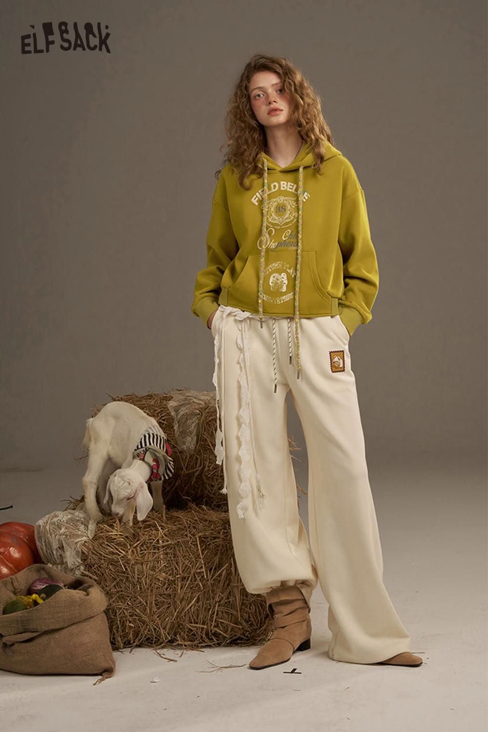 ELFSACK women's oversized print hoodie in mustard yellow paired with cream wide-leg pants