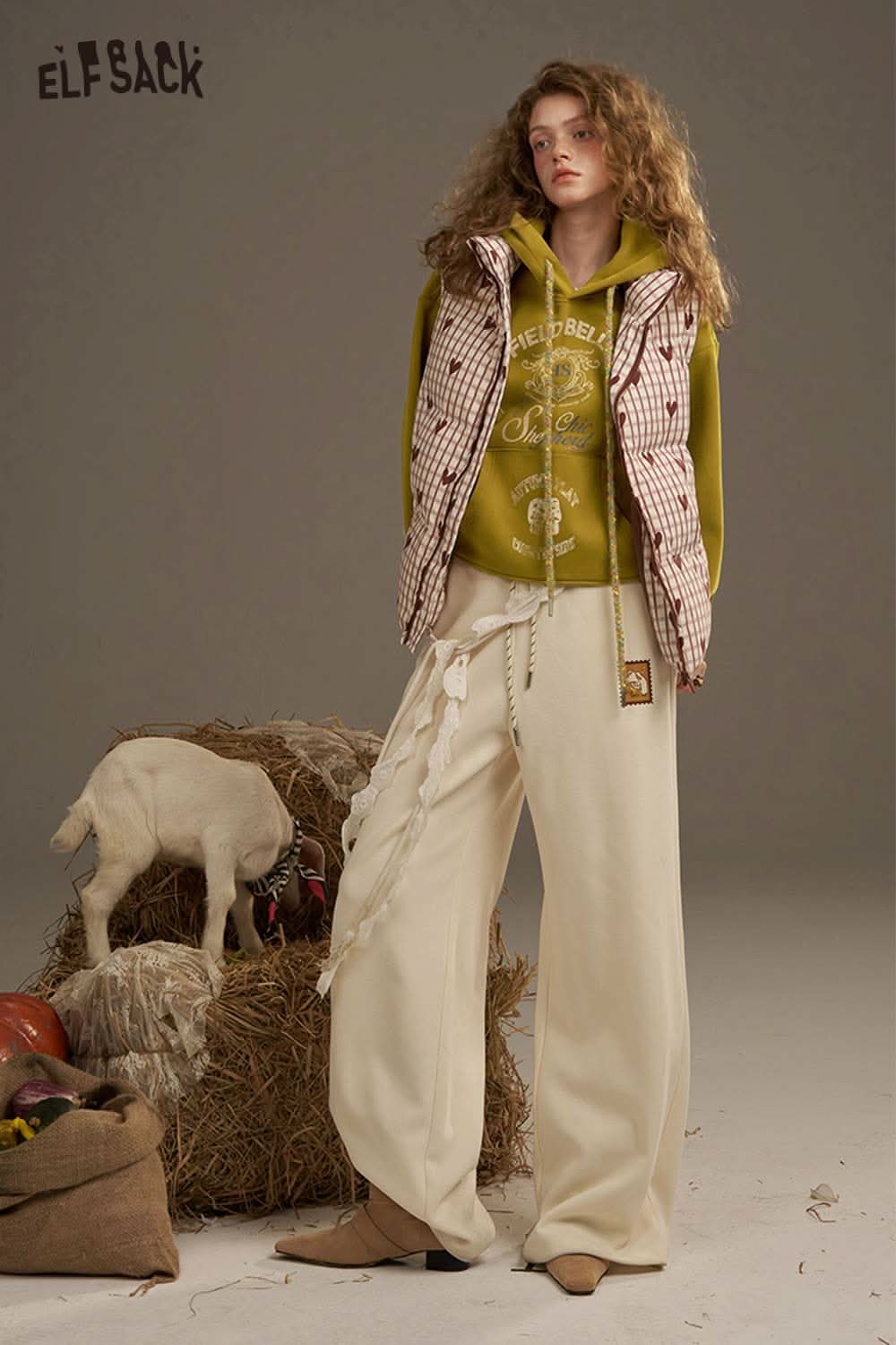 ELFSACK women's oversized print hoodie styled with a trendy vest and relaxed beige pants for a chic look