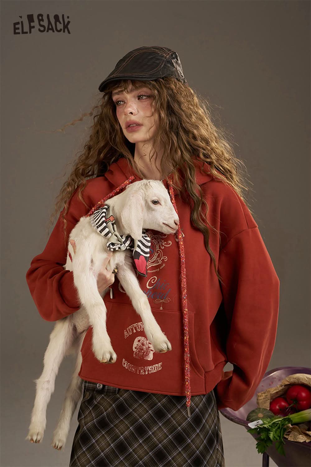 ELFSACK women's oversized print hoodie in red, featuring a cozy design with a model holding a puppy