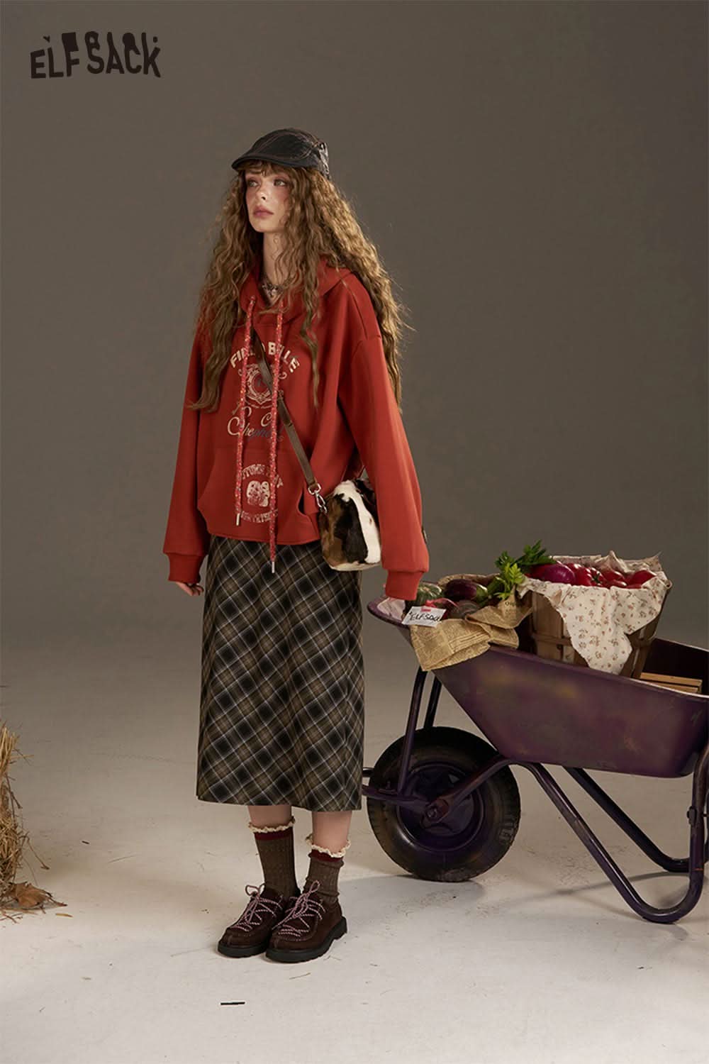 ELFSACK women's oversized print hoodie in red styled with a plaid skirt and accessories